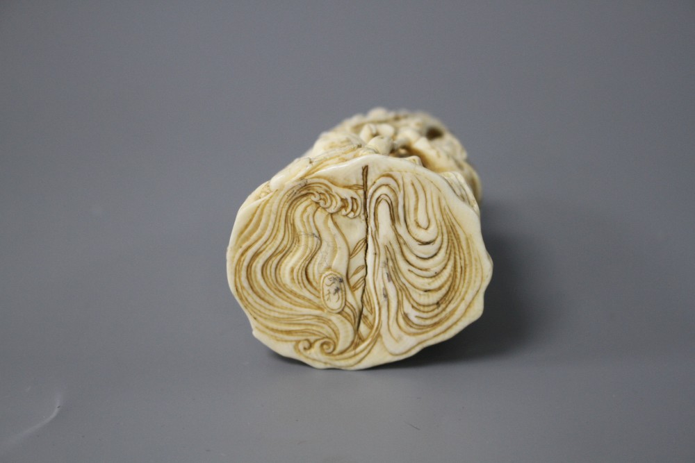 A Japanese Meiji period carved ivory group of a goddess and dragon with attendants, signed to the underside, height 8cm